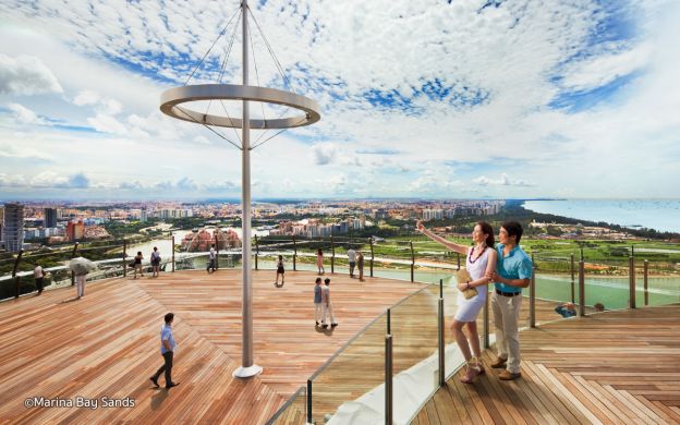 Enamored couple embracing the stunning cityscape, captivated by the awe-inspiring view from Marina Bay Sands Skypark Observation Deck.